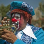 A clown plays a trumpet during the Inter